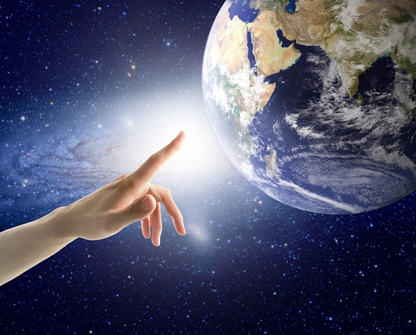 Man's hand touching the Earth